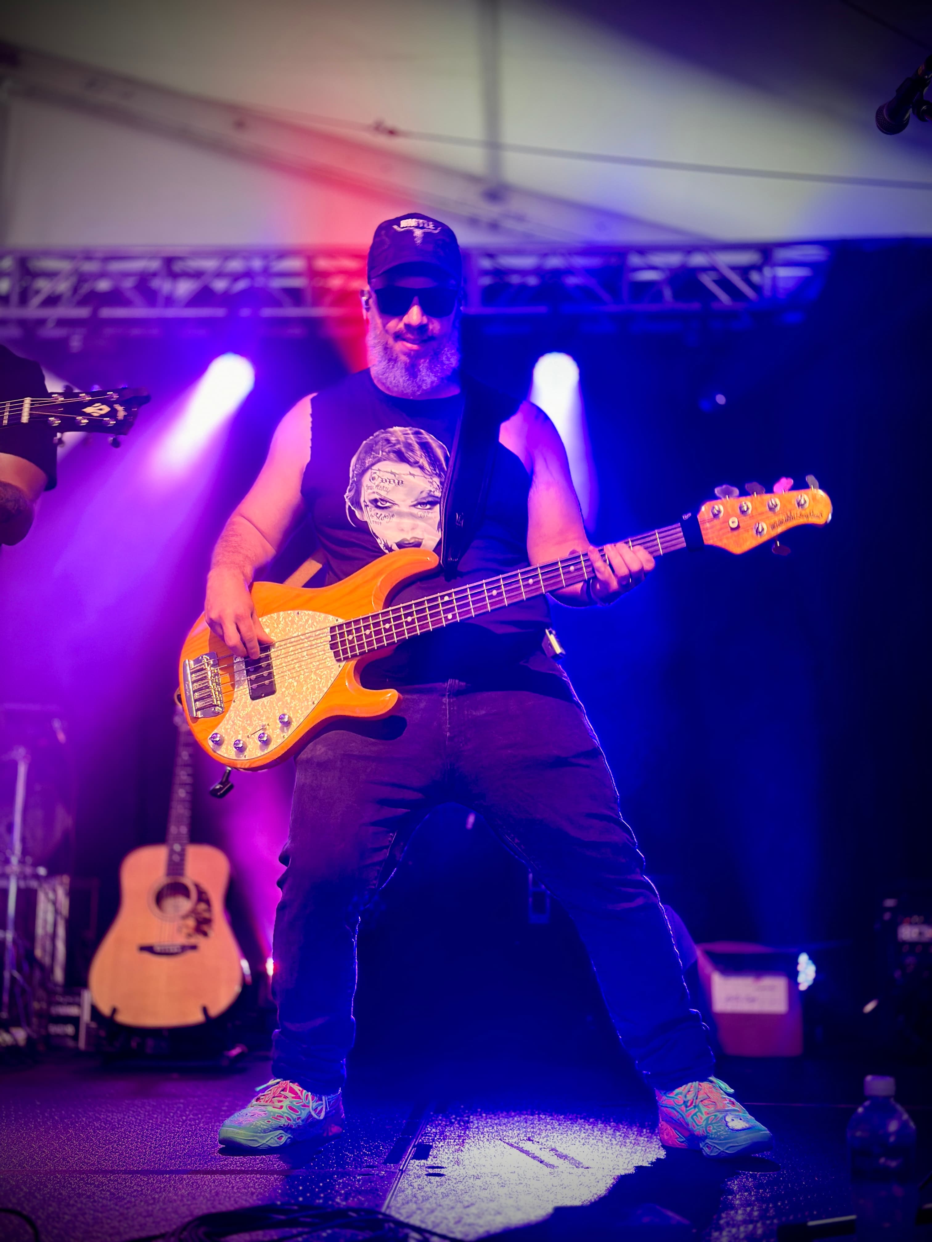 HIRTLE bassist performing under purple stage lights