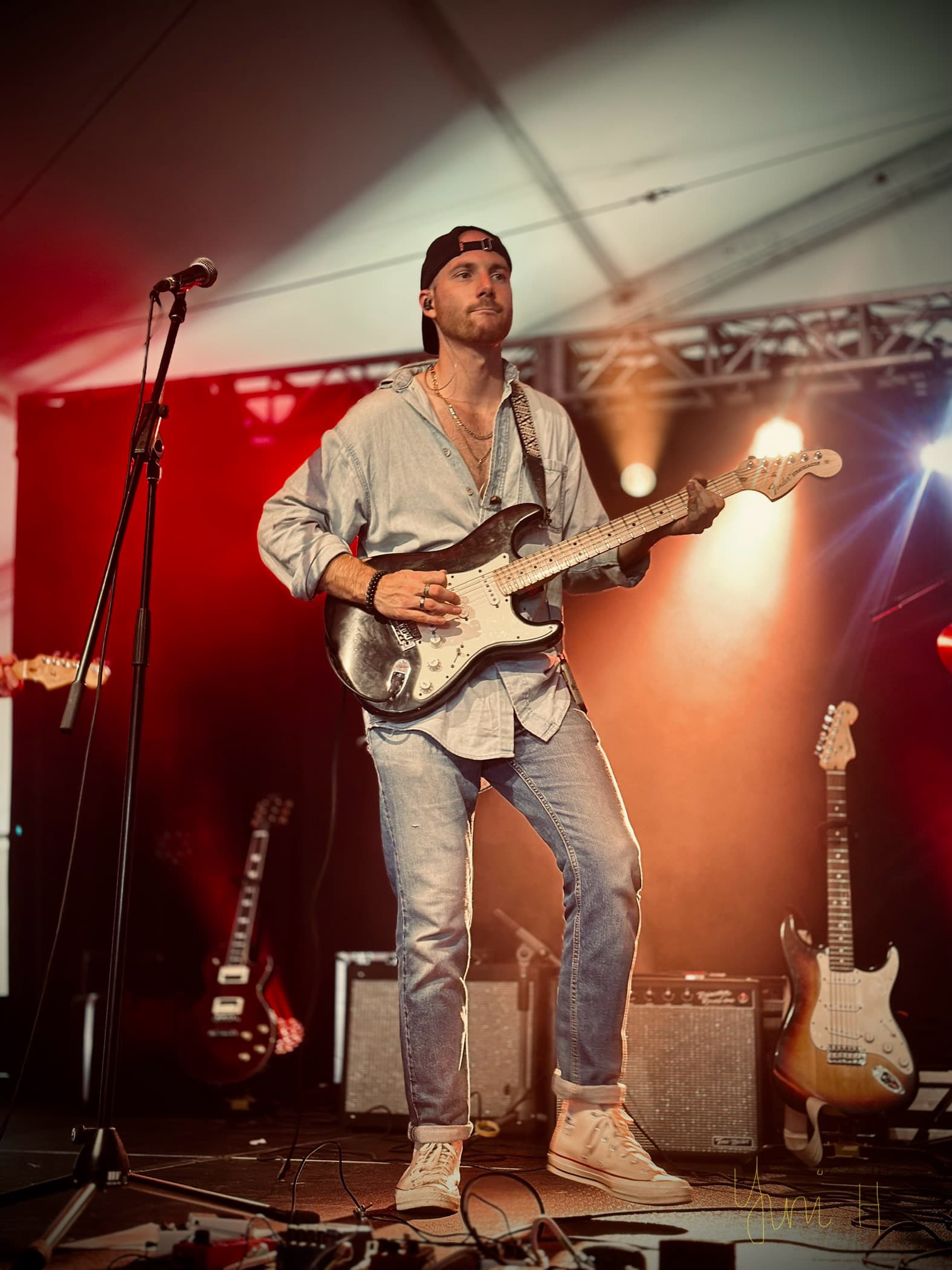 HIRTLE guitarist playing under red stage lights